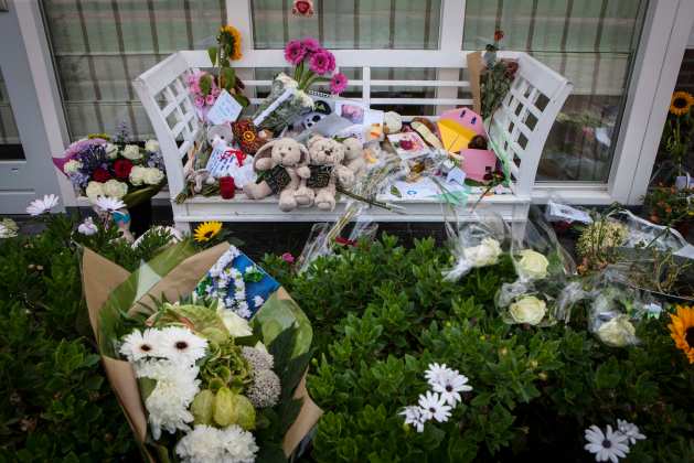 Flowers, toys and teddy bears are placed on a bench in front of the house of a family, who were all killed in Malaysia Airlines flight MH17 crash, in Rosmalen