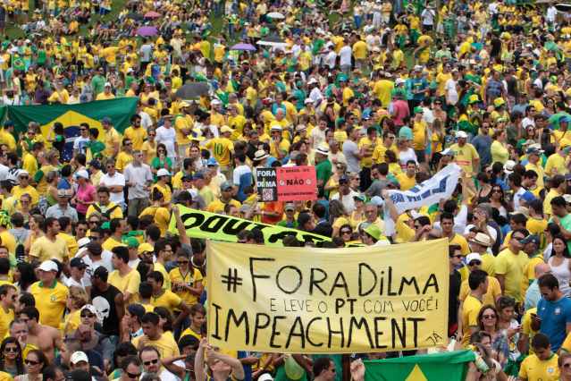 Demonstrators hold a banner during a protest against Brazil's President Dilma Rousseff in Brasilia