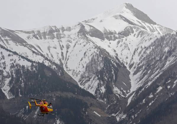 A rescue helicopter from the French Securite Civile flies towards the French Alps during a rescue operation near the crash site of an Airbus A320
