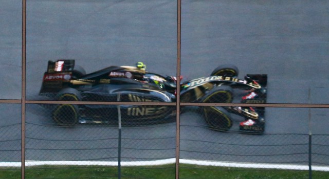 Lotus Formula One driver  Maldonado of Venezuela is reflected in a window during second practice session of the Austrian F1 Grand Prix in Spielberg