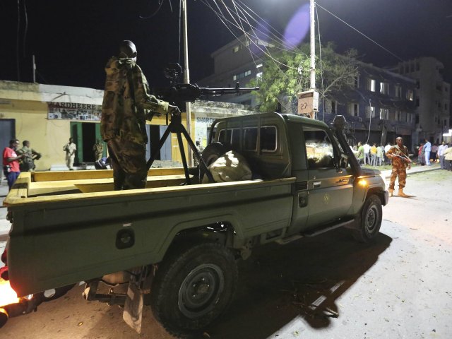 Somali government soldiers arrive at the scene of an explosion at the gate of Wehliya hotel in Somalia's capital Mogadishu