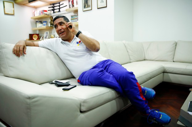 Venezuela's Interior Minister Rodriguez talks on his mobile phone during an interview with Reuters in Caracas