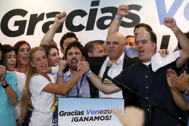 Lilian Tintori (centre L), wife of jailed Venezuelan opposition leader Leopoldo Lopez, celebrates next to candidates of the Venezuelan coalition of opposition parties (MUD) during a news conference on the election in Caracas early December 7, 2015. Venezuela's opposition won control of the legislature from the ruling Socialists for the first time in 16 years on Sunday, giving them a long-sought platform to challenge President Nicolas Maduro. REUTERS/Carlos Garcia Rawlins 