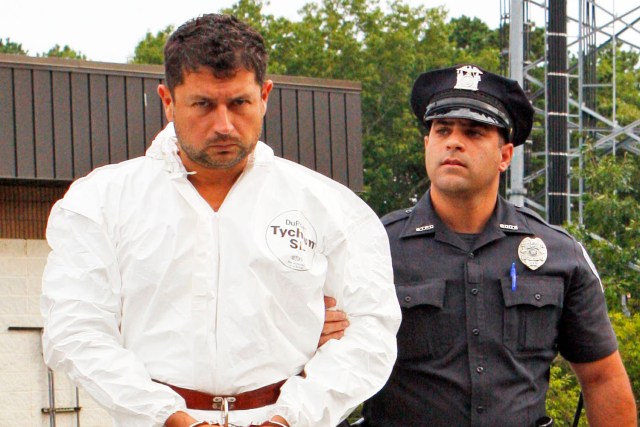 HAMPTON BAYS, NY - August 31, 2015: This is Sean Ludwick of Sag Harbor, being led out of the Southampton Police Department to be transported to Southampton Town Justice Court for arraignment. He is being charged with DWI and leaving the scene of a fatal accident. Ludwick's passenger was killed in the one-car MVA that occurred early Sunday morning on Rolling Hills Court in Sag Harbor.     (Photo by Victor Alcorn)   PHOTO CREDIT GOES TO VICTORALCORN.COM