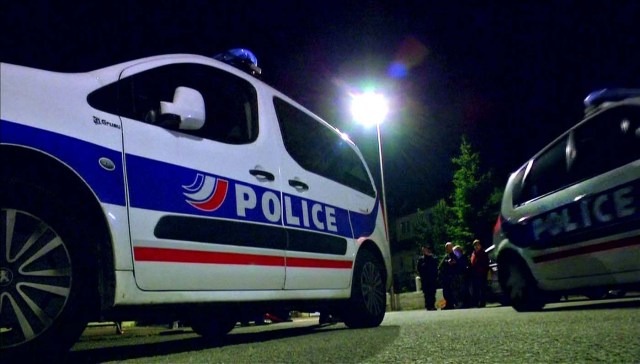 Still image taken from video shows Police vehicles at the scene near where a French police commander was stabbed to death in front of his home in the Paris suburb of Magnanville, France, June 14, 2016. REUTERS/Reuters TV