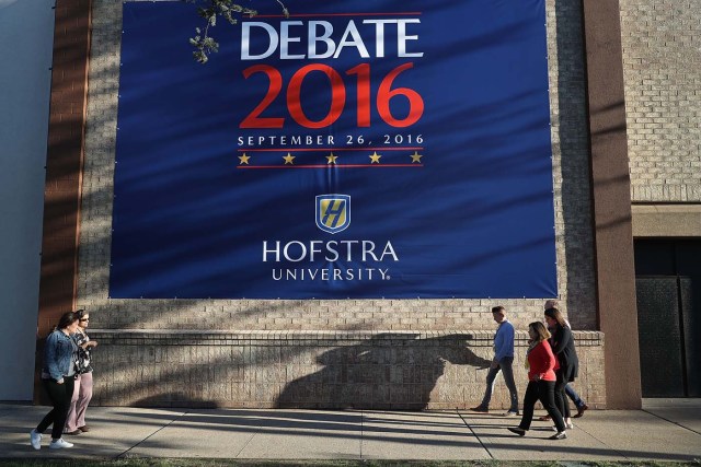 HEMPSTEAD, NY - SEPTEMBER 24: A debate sign hangs on a wall outside the media center setup for the first U.S. presidential debate at Hofstra University on September 24, 2016 in Hempstead, New York. Democratic presidential candidate Hillary Clinton is scheduled to debate Republican presidential candidate Donald Trump on September 26.   Joe Raedle/Getty Images/AFP