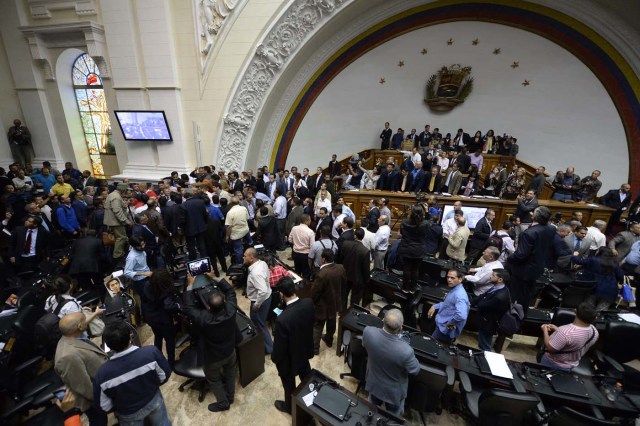 Supporters of Venezuelan President Nicolas Maduro force their way to the National Assembly during an extraordinary session called by opposition leaders, in Caracas on October 23, 2016. The opposition Democratic Unity Movement (MUD) called a Parliamentary session to debate putting President Nicolas Maduro on trial to "restore democracy" in an emergency session that descended into chaos as supporters of the leftist leader briefly seized the chamber. / AFP PHOTO / FEDERICO PARRA