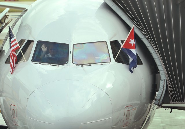 (FILES) This file photo taken on September 06, 2016 shows a pilot waving as he prepares to push back from the gate in American Airlines Flight 903, becoming the first commercial flight from Miami to Cuba in 55-years, in Miami, Florida.  As Cuba continues to mourn the death of Fidel Castro, the first regular commercial flight between Miami and Havana since the US and Cuba restored diplomatic relations after five decades of Cold War enmity, will depart at 1230 GMT on Monday, November 28, 2016, and arrive in Havana an hour later at 1330 GMT.    / AFP PHOTO / GETTY IMAGES NORTH AMERICA / JOE RAEDLE