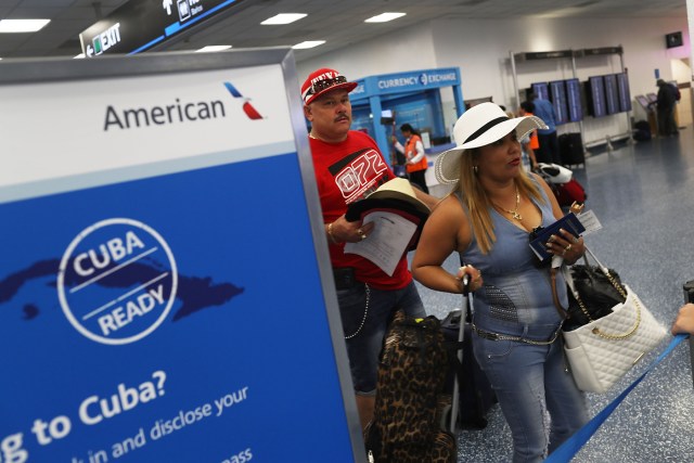 (FILES) This file photo taken on September 7, 2016 shows Juan Perez (L) and Marlini Gallan as they check in to their American Airlines Flight to Cuba which was the first commercial flight from Miami to Cuba in 55 years in Miami, Florida.  As Cuba continues to mourn the death of Fidel Castro, the first regular commercial flight between Miami and Havana since the US and Cuba restored diplomatic relations after five decades of Cold War enmity, will depart at 1230 GMT on November 28, 2016, and arrive in Havana an hour later at 1330 GMT.    / AFP PHOTO / GETTY IMAGES NORTH AMERICA / JOE RAEDLE