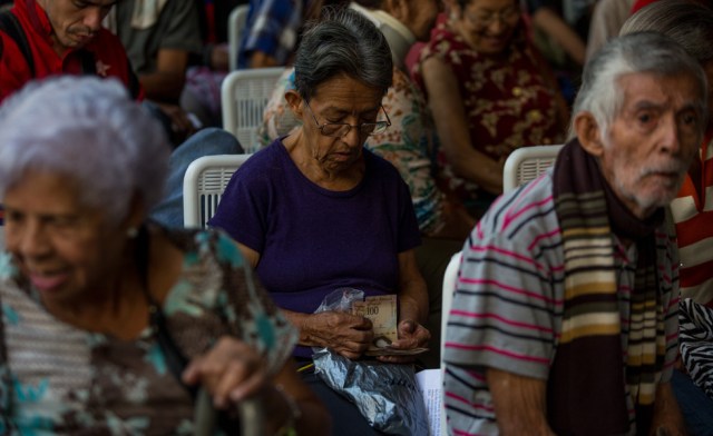 Los venezolanos que aún conservan billetes de 100 bolívares deberán depositarlos a partir de este viernes en el Banco Central, mientras se espera que empiecen a circular los billetes y monedas del nuevo cono monetario. EFE/ MIGUEL GUTIÉRREZ 