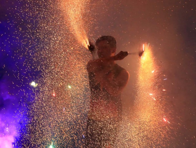 Alan Boi, a fire dancer, performs during New Year celebrations in Luneta park, metro Manila, Philippines December 31, 2016. REUTERS/Romeo Ranoco