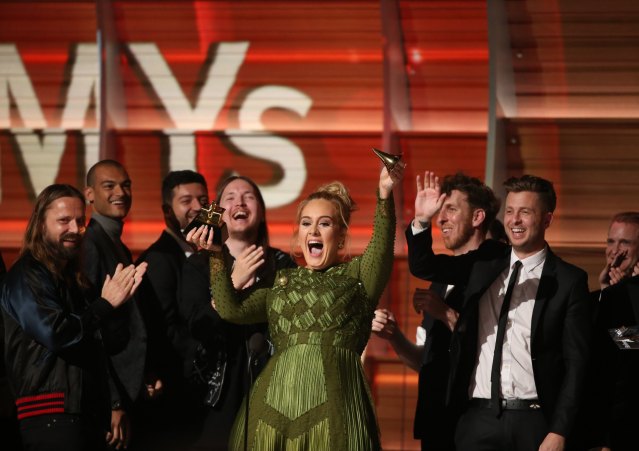 Adele breaks the Grammy for Record of the Year for "Hello" after having it presented to her at the 59th Annual Grammy Awards in Los Angeles, California, U.S., February 12, 2017. REUTERS/Lucy Nicholson