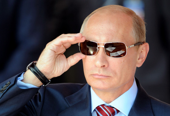 Russian Prime Minister Vladimir Putin adjusts his sunglasses as he watches an air show during MAKS-2011, the International Aviation and Space Show, in Zhukovsky, outside Moscow, on August 17, 2011.