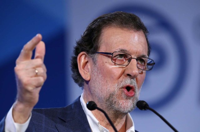 Spain's Prime minister Mariano Rajoy gestures during a meeting in Hospitalet de Llobregat, near Barcelona, Spain, March 26, 2017. The banner reads "Catalonia, with Spain. Go ahead!". REUTERS/Albert Gea