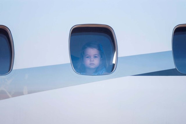 Princess Charlotte, daughter of Britain's Prince William, Duke of Cambridge and his wife Kate, the Duchess of Cambridge peers out of the airplane window upon the arrival at the airport in Berlin on July 19, 2017. REUTERS/Steffi Loos/POOL