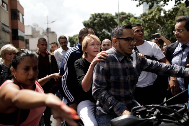 Venezuela's chief prosecutor Luisa Ortega is seen on a motorbike after a flash visit to the Public Prosecutor's office in Caracas, Venezuela August 5, 2017. REUTERS/Ueslei Marcelino