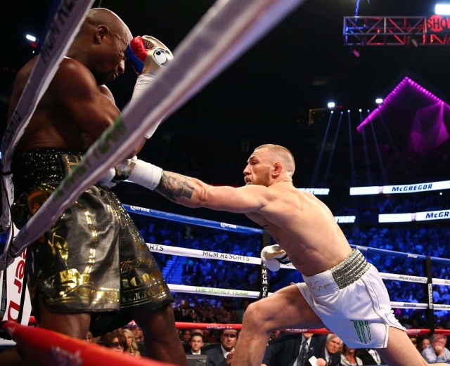 Aug 26, 2017; Las Vegas, NV, USA; Conor McGregor moves in against Floyd Mayweather Jr. in the first round at T-Mobile Arena. Mandatory Credit: Mark J. Rebilas-USA TODAY Sports