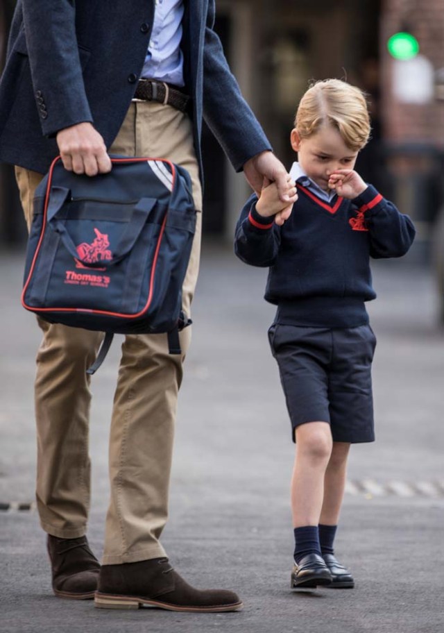 Prince George holds his father Britain's Prince William's hand as he arrives on his first day of school at Thomas's school in Battersea, London, September 7, 2017. REUTERS/Richard Pohle/Pool