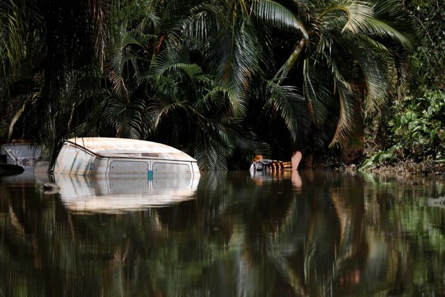 A car submerged in flood waters is seen close to the dam of the Guajataca lake after the area was hit by Hurricane Maria in Guajataca, Puerto Rico September 23, 2017. REUTERS/Carlos Garcia Rawlins