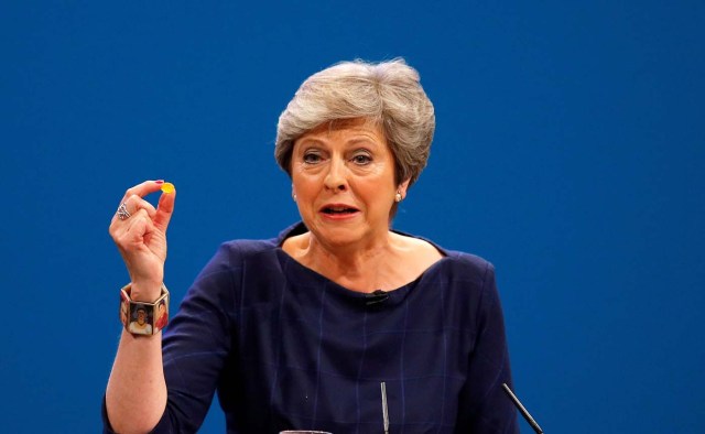 Britain's Prime Minister Theresa May holds up a cough sweet after suffering a coughing fit whilst addressing the Conservative Party conference in Manchester, October 4, 2017. REUTERS/Phil Noble