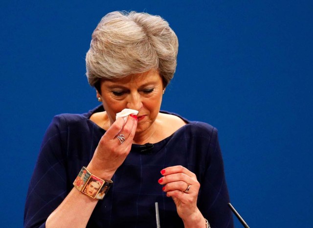 Britain's Prime Minister Theresa May wipes her nose after she suffered a coughing fit whilst addressing the Conservative Party conference in Manchester, October 4, 2017. REUTERS/Phil Noble