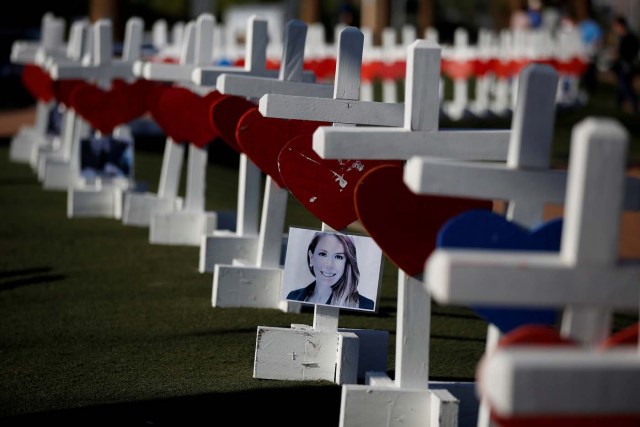 A photograph hangs from one of the 58 white crosses set up for the victims of the Route 91 music festival mass shooting in Las Vegas, Nevada, U.S., October 5, 2017. REUTERS/Chris Wattie TPX IMAGES OF THE DAY