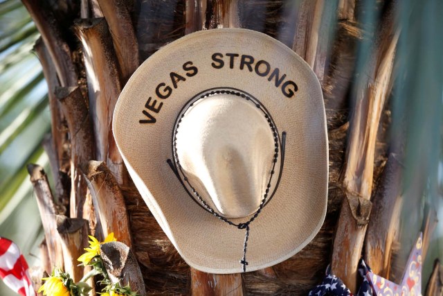 A cowboy hat with the words "Vegas Strong" and a rosary are pictured a makeshift memorial in the middle of Las Vegas Boulevard following the mass shooting in Las Vegas, Nevada, U.S., October 6, 2017. REUTERS/Chris Wattie