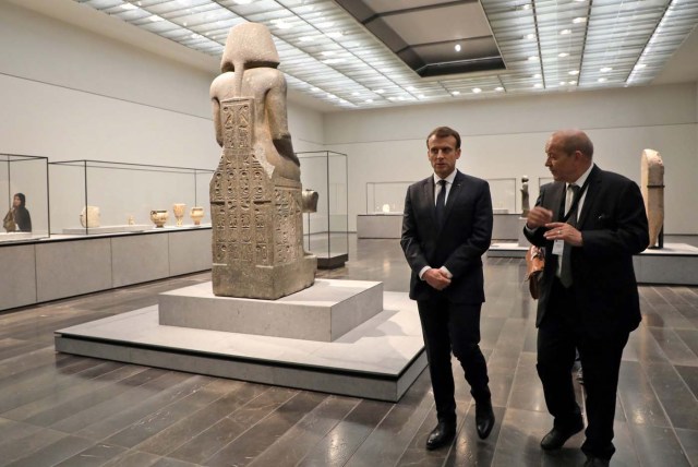 French President Emmanuel Macron (L) and French Foreign Minister Jean-Yves Le Drian visit the Louvre Abu Dhabi Museum during its inauguration in Abu Dhabi, November 8, 2017. REUTERS/Ludovic Marin/Pool