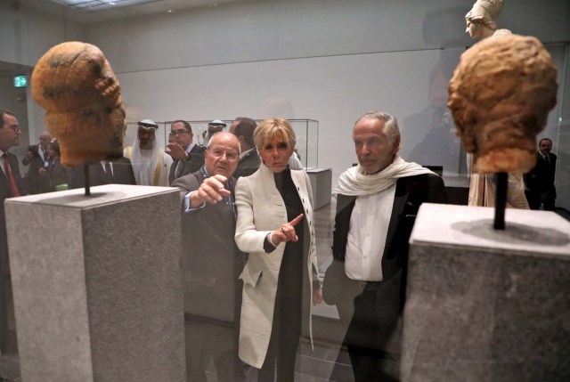 Brigitte Macron, the wife of the French president, looks at art as she visits the Louvre Abu Dhabi Museum during its inaugurationin Abu Dhabi, UAE, November 8, 2017. Picture taken November 8, 2017. REUTERS/Ludovic Marin/Pool