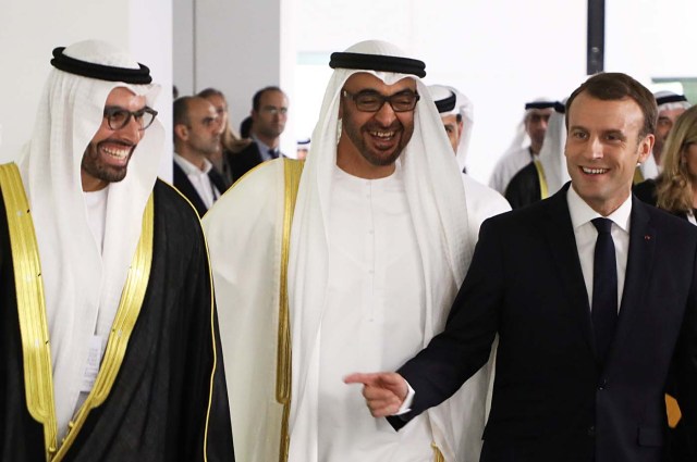 (From L to R) Chairman of Abu Dhabi's Tourism and Culture Authority, Mohamad Khalifa al-Mubarak, Abu Dhabi Crown Prince Mohammed bin Zayed al-Nahyan and French President Emmanuel Macron laugh as they visit the Louvre Abu Dhabi Museum during its inauguration in Abu Dhabi, UAE, November 8, 2017. Picture taken November 8, 2017. REUTERS/Ludovic Marin/Pool