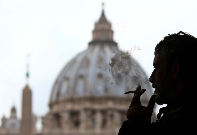 A man smokes a cigarette in front of St. Peter Square, in Rome, Italy November 9, 2017. REUTERS/Alessandro Bianchi