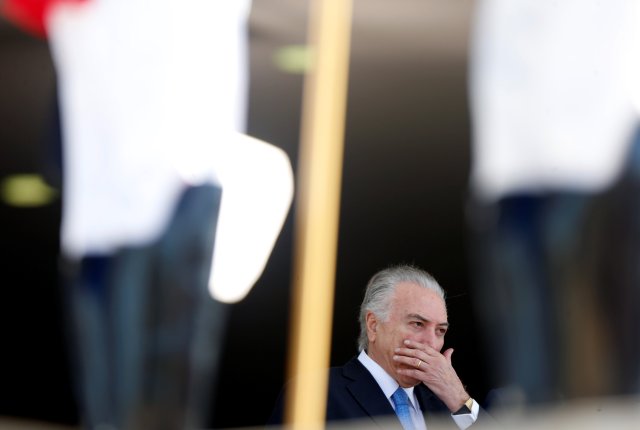 Brazil's President Michel Temer gestures as he stands behind honour guard before welcoming his counterparts during Mercosur trade bloc annual summit in Brasilia, Brazil, December 21, 2017. REUTERS/Adriano Machado