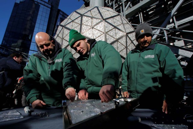 Workers prepare a panel of Waterford Crystal triangles before attaching it to the Times Square New Year's Eve Ball on the roof of One Times Square in Manhattan, New York, U.S., December 27, 2017. REUTERS/Andrew Kelly