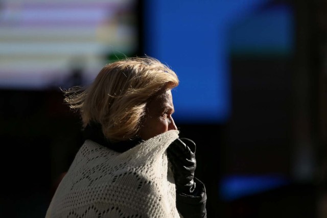 A woman bundles up against the cold temperature as she walks in Times Square in Manhattan, New York, U.S., December 28, 2017. REUTERS/Amr Alfiky