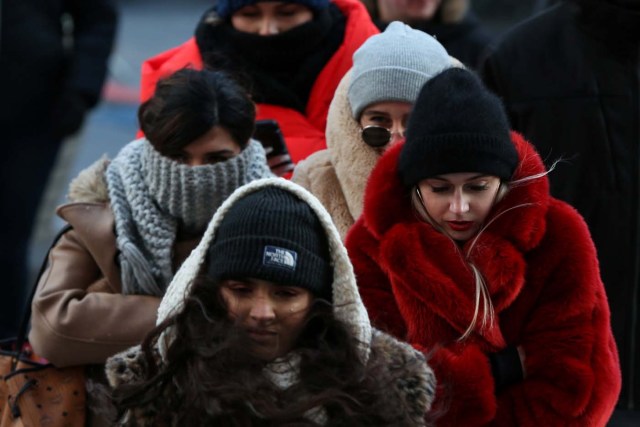 People bundle up against the cold temperature as they walk in Times Square in Manhattan, New York, U.S., December 28, 2017. REUTERS/Amr Alfiky