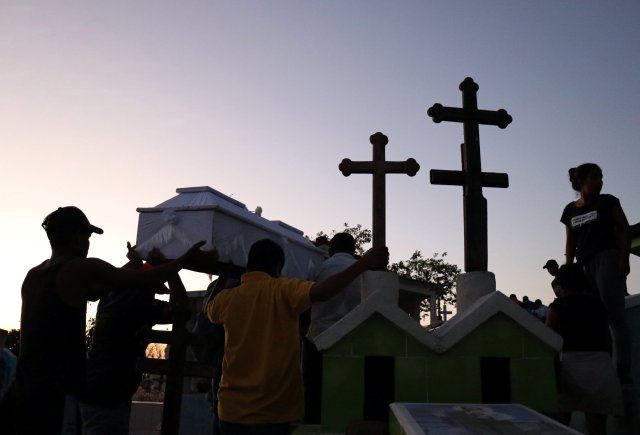 People carry a coffin during the funeral of people who were killed after a military helicopter carrying Mexico's interior minister and the governor of the southern state of Oaxaca, crashed on top of two vans in an open field while trying to land in Santiago Jamiltepec, Mexico February 17, 2018. REUTERS/Jorge Luis Plata NO RESALES. NO ARCHIVES.