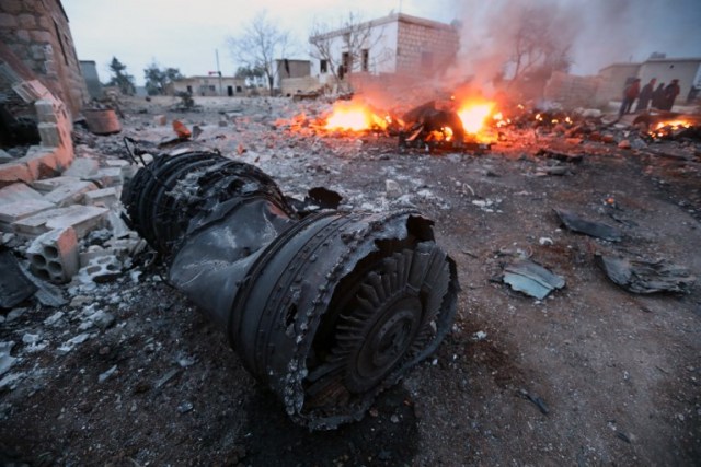 A picture taken on February 3, 2018, shows smoke billowing from the site of a downed Sukhoi-25 fighter jet near the Syrian city of Saraqib, southwest of Aleppo. Rebel fighters shot down a Russian plane over Syria's northwest Idlib province and captured its pilot, the Syrian Observatory for Human Rights said. / AFP PHOTO / OMAR HAJ KADOUR