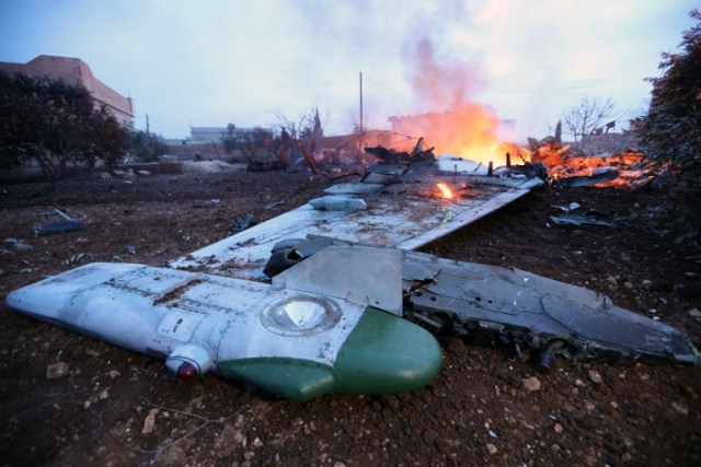 A picture taken on February 3, 2018, shows smoke billowing from the site of a downed Sukhoi-25 fighter jet near the Syrian city of Saraqib, southwest of Aleppo. Rebel fighters shot down a Russian plane over Syria's northwest Idlib province and captured its pilot, the Syrian Observatory for Human Rights said. / AFP PHOTO / OMAR HAJ KADOUR