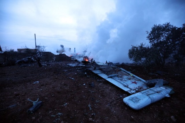 A picture taken on February 3, 2018, shows smoke billowing from the site of a downed Sukhoi-25 fighter jet near the Syrian city of Saraqib, southwest of Aleppo. Rebel fighters shot down a Russian plane over Syria's northwest Idlib province and captured its pilot, the Syrian Observatory for Human Rights said. / AFP PHOTO / OMAR HAJ KADOUR