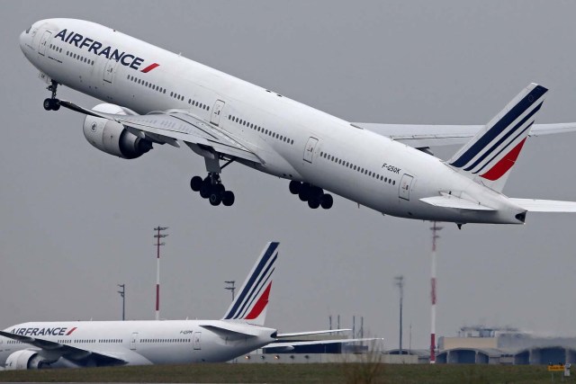 An Air France Airbus Boeing 777 airplane takes off past a control tower at the Charles-de-Gaulle airport in Roissy, near Paris, France, March 23, 2018. REUTERS/Pascal Rossignol