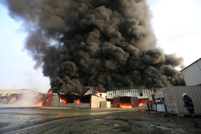 Firefighters try to extinguish a fire engulfing warehouse of the World Food Programme in Hodeida, Yemen March 31, 2018. REUTERS/Abduljabbar Zeyad