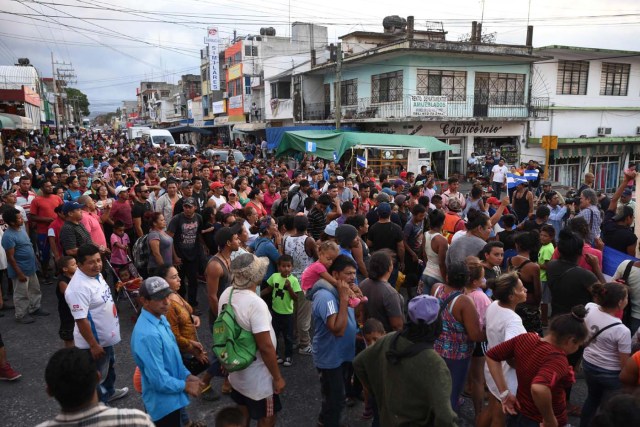 Central American migrants taking part in a caravan called "Migrant Viacrucis" towards the United States march to protest against US President Donald Trump's policies as they remain stranded in Matias Romero, Oaxaca State, Mexico, on April 3, 2018.  The hundreds of Central Americans in the "Way of the Cross" migrant caravan have infuriated Trump, but they are not moving very fast -- if at all -- and remain far from the US border. As Trump vowed Tuesday to send troops to secure the southern US border, the caravan was camped out for the third straight day in the town of Matias Romero, in southern Mexico, more than 3,000 kilometers (1,800 miles) from the United States.  / AFP PHOTO / VICTORIA RAZO