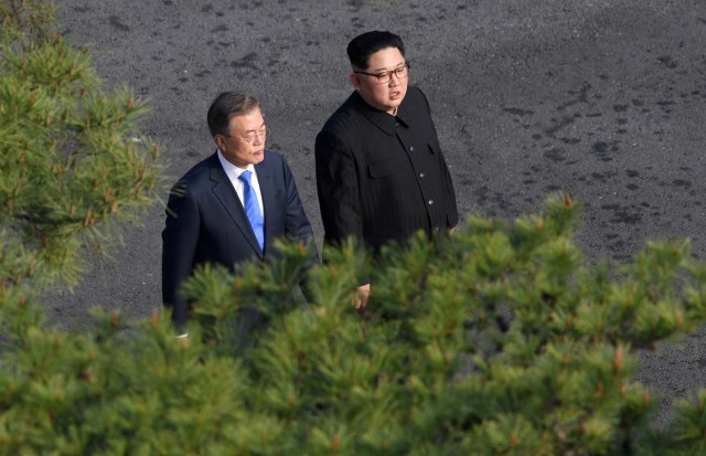 South Korean President Moon Jae-in and North Korean leader Kim Jong Un walk together at the truce village of Panmunjom inside the demilitarized zone separating the two Koreas, South Korea, April 27, 2018. Korea Summit Press Pool/Pool via Reuters