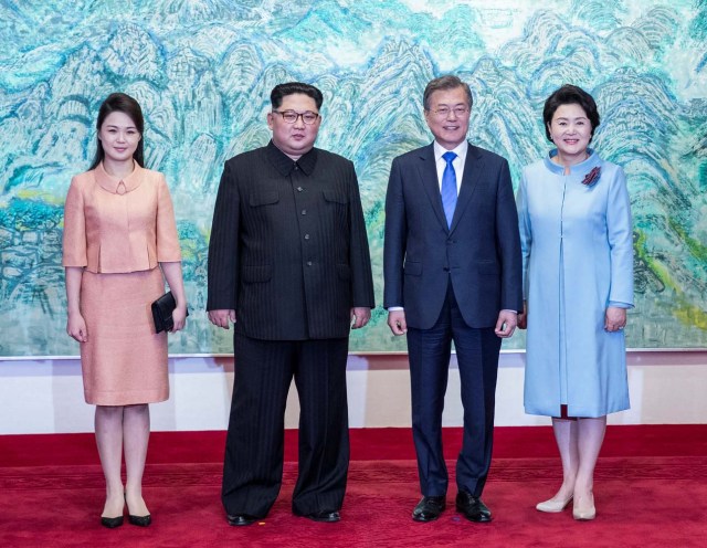 South Korean President Moon Jae-in and North Korean leader Kim Jong Un pose with Kim's wife Ri Sol Ju and Moon's wife Kim Jung-sook at the truce village of Panmunjom inside the demilitarized zone separating the two Koreas, South Korea, April 27, 2018. Korea Summit Press Pool/Pool via Reuters
