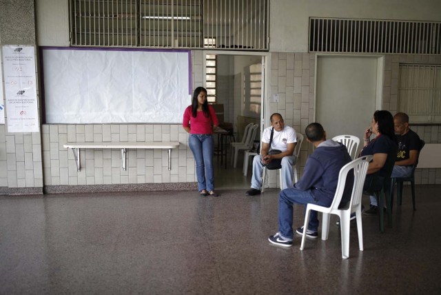 Electoral officials await voters at a polling station during the presidential election in Caracas, Venezuela, May 20, 2018. REUTERS/Carlos Garcia Rawlins