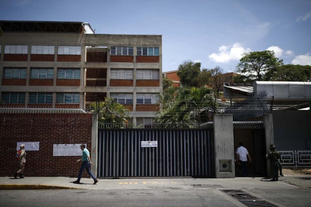 Venezuelan soldiers (R), a militia member and civilians at a polling station during the presidential election in Caracas, Venezuela, May 20, 2018. REUTERS/Carlos Garcia Rawlins