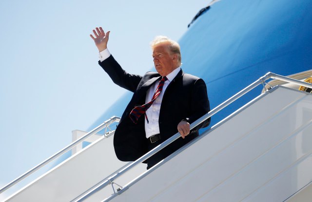 U.S. President Donald Trump waves as he arrives to attend the nearby G7 Summit in Charlevoix after landing aboard Air Force One at Canadian Forces Base Bagotville in La Baie, Quebec, Canada, June 8, 2018. REUTERS/Leah Millis