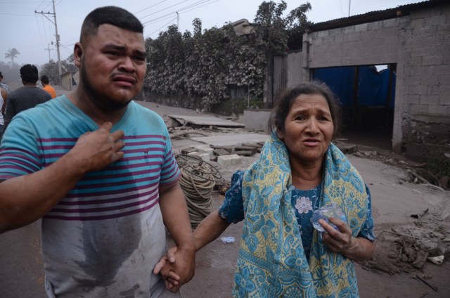 Un hombre y una mujer lamentan los daños en El Rodeo, Escuintla (Guatemala) hoy, domingo 3 de junio de 2018, luego de la erupción del volcán de Fuego, que ha dejado al menos 25 muertos, 20 heridos y más de 1,7 millones de personas afectadas. EFE/NOE PÉREZ